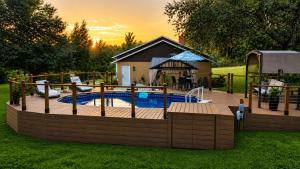 a wooden deck with a pool and a playground at Serene Mountain Retreat With Pool in Clermont