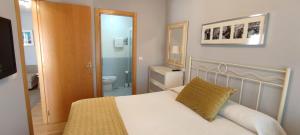 a bedroom with a bed and a bathroom with a toilet at Costa de Llanes in Posada de Llanes +14 photos