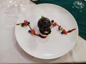 a white plate with a chocolate dessert on it at Naicha Green in Tetebatu