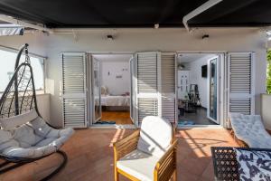 a living room with two chairs and a swing at Jakov & Antonia Heritage Estate in Hvar