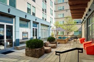 a courtyard in a building with chairs and tables at Element by Marriott Arundel Mills BWI Airport in Hanover