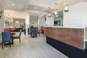 a restaurant with a bar with chairs and tables at Hotel 1550 - SFO Airport FREE Shuttle in San Bruno