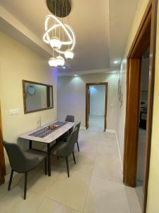 a dining room with a table and chairs at You Royal in Dakar