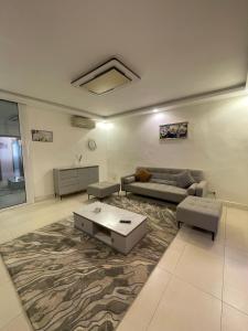 a living room with a couch and a table at You Royal in Dakar
