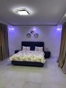 a bedroom with a bed with two soccer balls on the wall at You Royal in Dakar