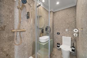 a bathroom with a shower and a toilet at HOME1 - Lumes Boutique Hotel in Vienna