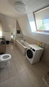 a bathroom with a tub and a toilet and a sink at Kampenhout appartement met terras en 4 slaap kamers in Kampenhout +46 photos