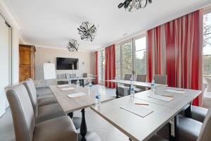 ein Konferenzraum mit einem langen Tisch und Stühlen in der Unterkunft La Ramade - Teritoria in Avranches