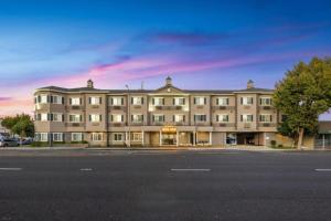 a large building sitting on the side of a street at Hotel 1550 - SFO Airport FREE Shuttle in San Bruno