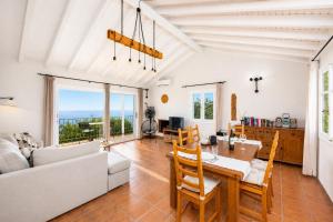 a living room with a table and a couch at Villa Gardenia in Vlachopoulátika