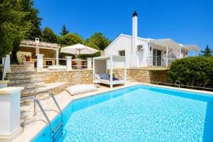 a house with a swimming pool in front of a house at Villa Gardenia in Vlachopoulátika