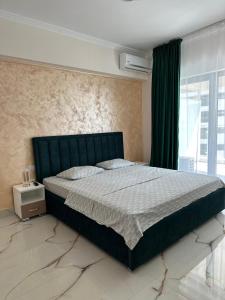 a bedroom with a large bed and a window at Grand Panorama Residence in Mamaia +234 photos