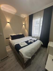 a bedroom with a large bed with towels on it at Blue class otel in Atakum +34 photos
