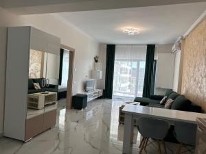 a living room with a couch and a table at Grand Panorama Residence in Mamaia