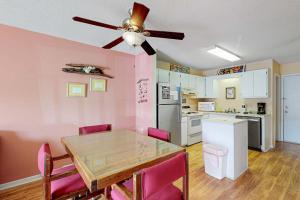 a kitchen with a dining table and a ceiling fan at Plantation East #3117 in Gulf Highlands