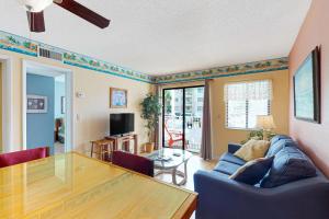 a living room with a blue couch and a table at Plantation East #3117 in Gulf Highlands