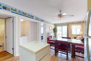 a kitchen and dining room with a table and chairs at Plantation East #3117 in Gulf Highlands +38 photos