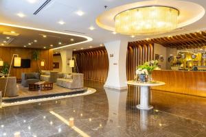 a lobby of a hotel with couches and a table at Adana Plaza Hotel in Adana