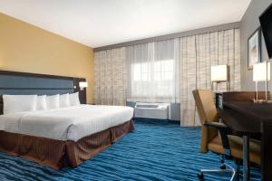 a hotel room with a bed and a desk at Hotel 1550 - SFO Airport FREE Shuttle in San Bruno