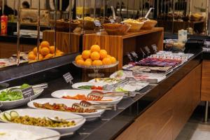 a buffet with plates of food on a table at Adana Plaza Hotel in Adana