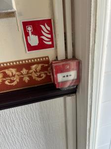 two boxes sitting on a shelf next to a door at Mayfair hotel Blackpool city centre in Blackpool