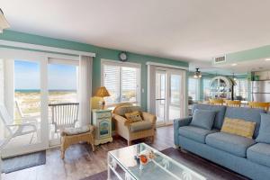 a living room with a blue couch and chairs at #1131 The Mermaid Pad in Gulf Highlands
