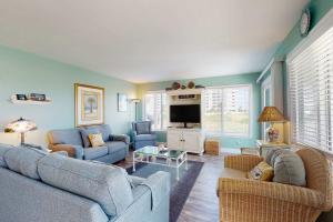 a living room with two couches and a tv at #1131 The Mermaid Pad in Gulf Highlands