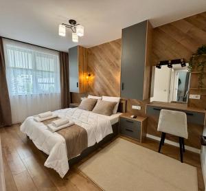 a bedroom with a large bed and a desk at Arena Apartment in Gotse Delchev +44 photos
