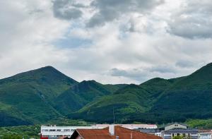 a group of green mountains with houses and buildings at Arena Apartment in Gotse Delchev