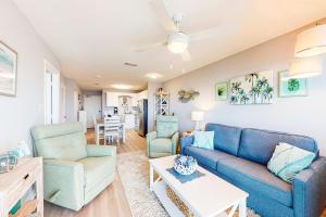 a living room with a blue couch and chairs at Plantation East #4504 in Gulf Highlands