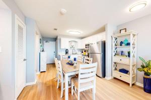 a kitchen and dining room with a table and chairs at Plantation East #4504 in Gulf Highlands