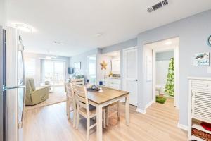 a kitchen and dining room with a table and chairs at Plantation East #4504 in Gulf Highlands