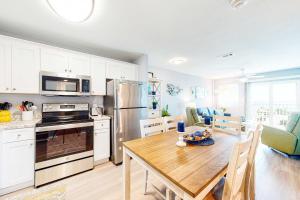a kitchen and dining room with a wooden table at Plantation East #4504 in Gulf Highlands