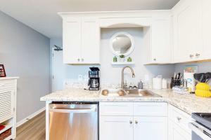 a kitchen with white cabinets and a sink at Plantation East #4504 in Gulf Highlands +46 photos