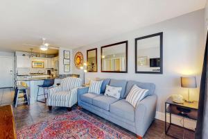 a living room with a couch and a kitchen at Plantation East #1110 in Gulf Shores