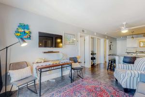 a living room with a table and a couch at Plantation East #1110 in Gulf Shores