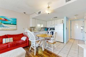 a living room with a red couch and a table at Plantation West #1261 in Gulf Highlands