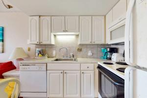 a kitchen with white cabinets and a sink at Plantation West #1261 in Gulf Highlands +25 photos