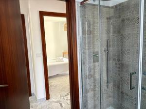 a bathroom with a shower with a glass door at Elba Essence Suites in Portoferraio +62 photos