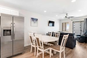 a kitchen and dining room with a table and a refrigerator at Plantation East #3312 in Gulf Highlands