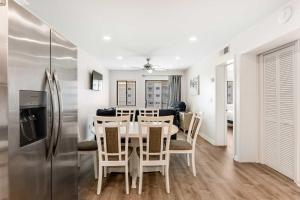 a kitchen and dining room with a table and a refrigerator at Plantation East #3312 in Gulf Highlands