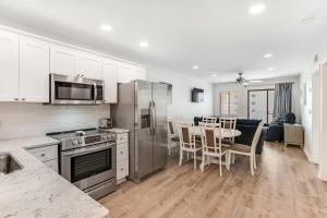a kitchen with stainless steel appliances and a table with chairs at Plantation East #3312 in Gulf Highlands