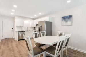 a kitchen and dining room with a table and chairs at Plantation East #3312 in Gulf Highlands +51 photos