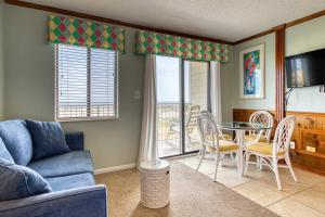 a living room with a couch and a table and chairs at Plantation East #1201 in Gulf Highlands