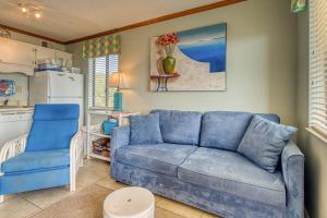a living room with a blue couch and a blue chair at Plantation East #1201 in Gulf Highlands
