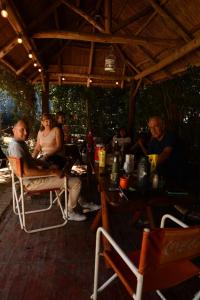 a group of people sitting around a table on a patio at Rincón de Rodríguez in General Rodríguez
