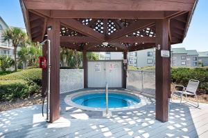 a wooden pavilion with a hot tub in a patio at Plantation West #1365 in Fort Morgan