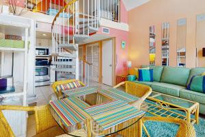 a living room with a couch and a table and chairs at Plantation West #1365 in Fort Morgan