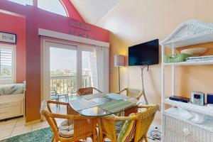 a dining room with a glass table and chairs at Plantation West #1365 in Fort Morgan