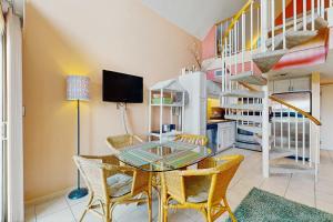 a dining room with a glass table and chairs at Plantation West #1365 in Fort Morgan +28 photos